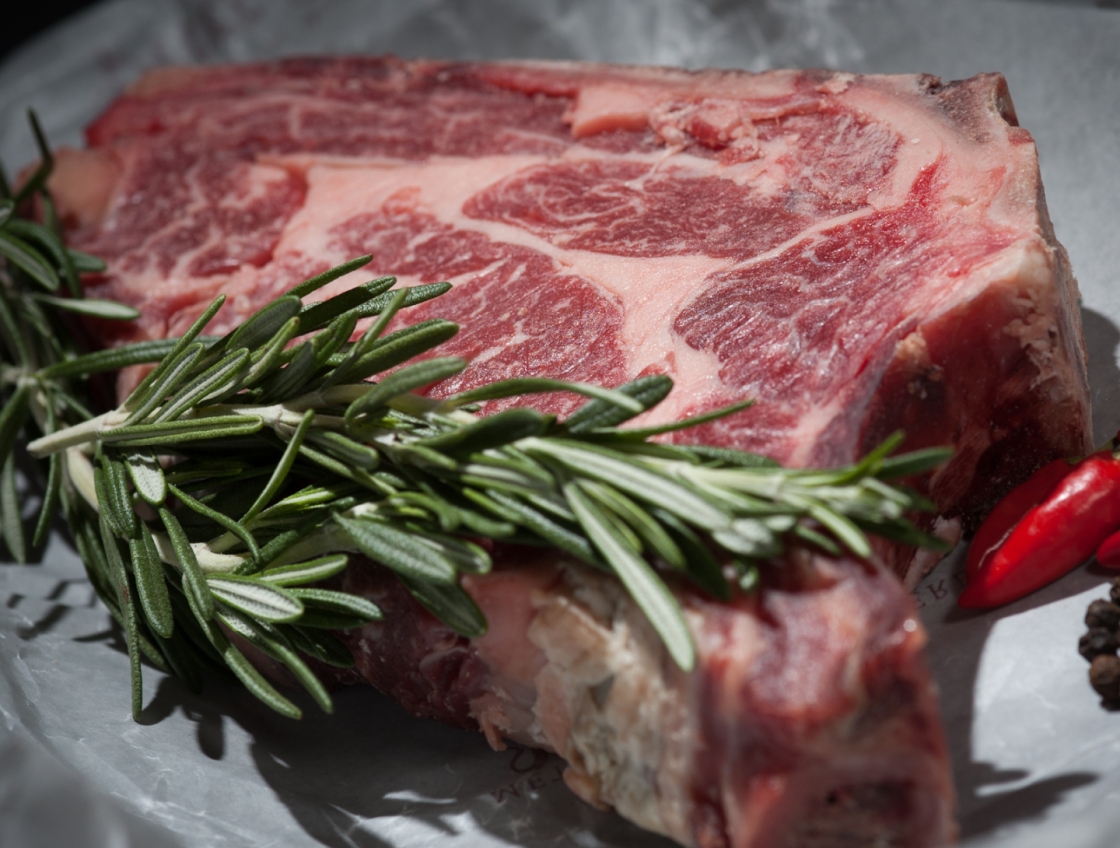 fresh porterhouse steak with sprig garnish